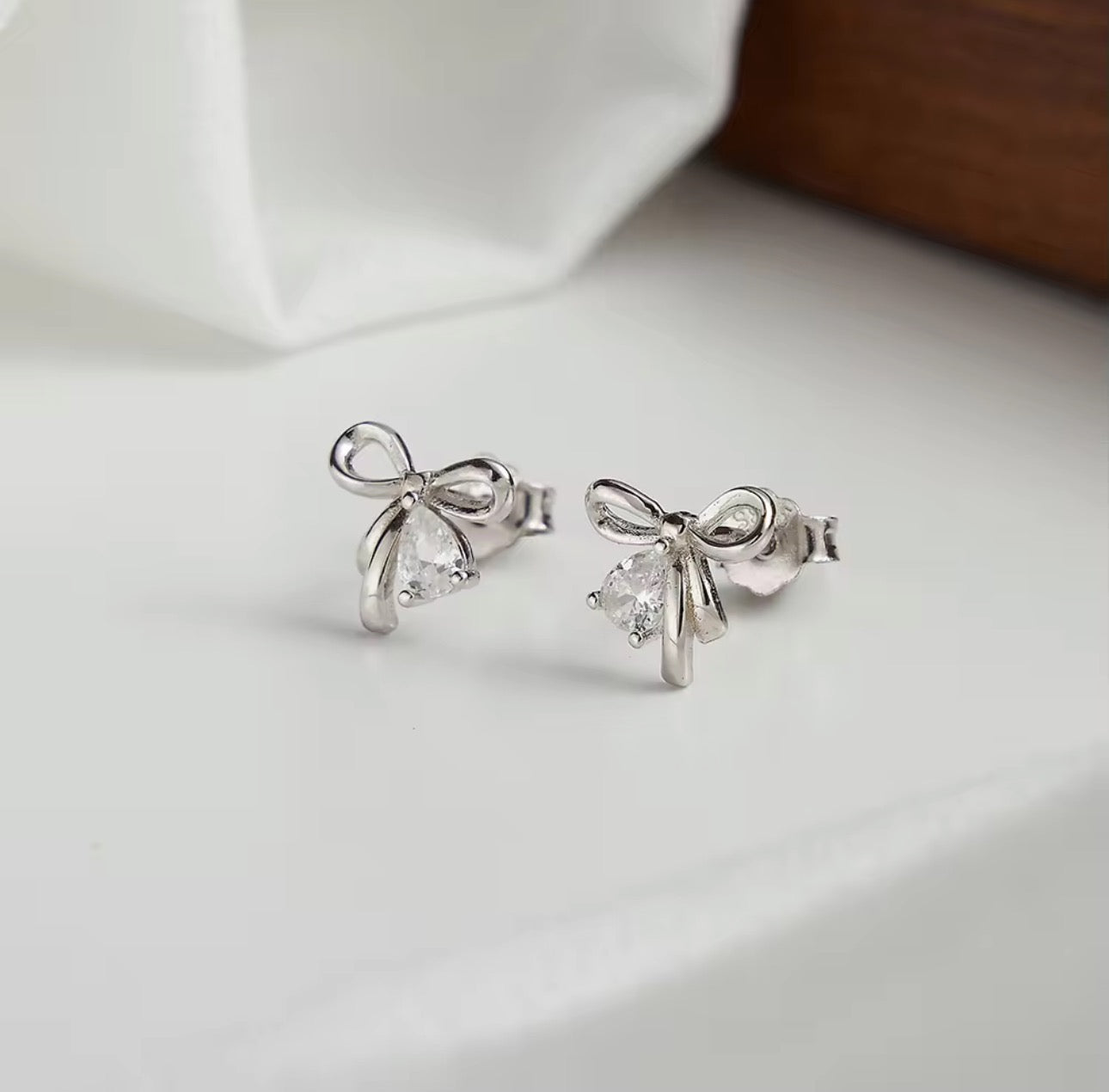 Golden Grace Bow Stud Earrings - Rhodium Plated
