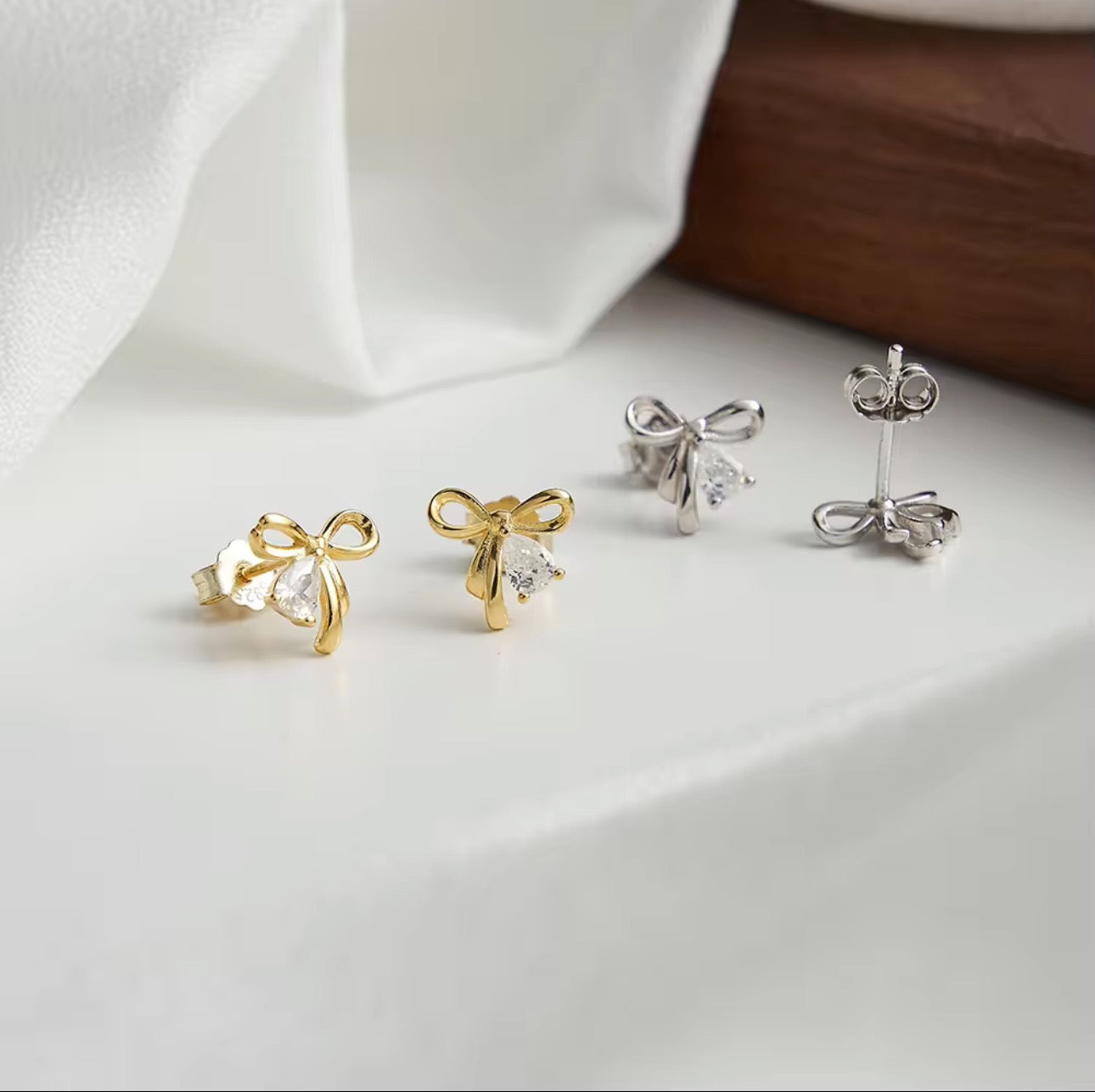 Golden Grace Bow Stud Earrings - Rhodium Plated